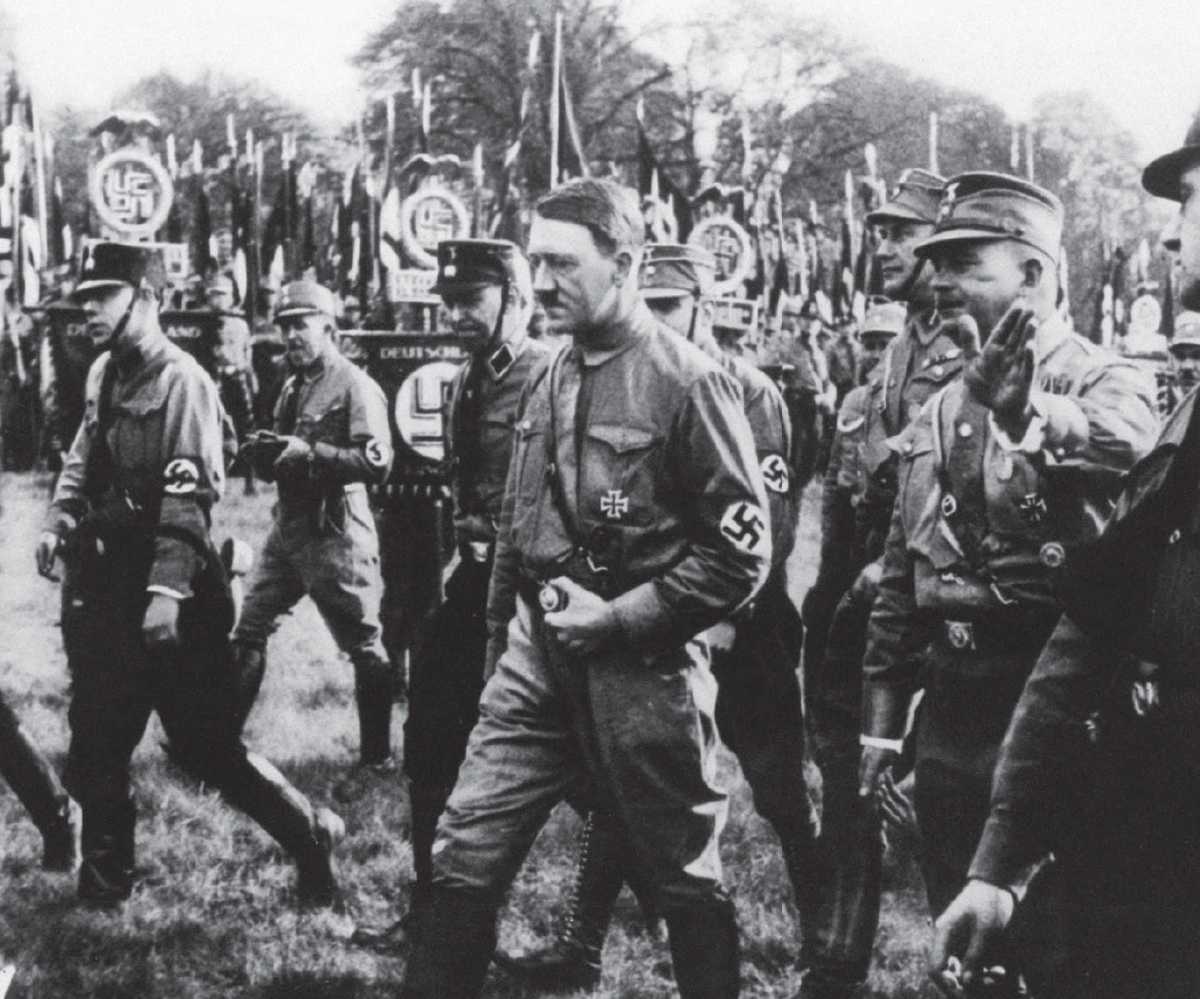 Hitler and Rhm march side by side at a rally in 1931 surrounded by men of the - photo 2