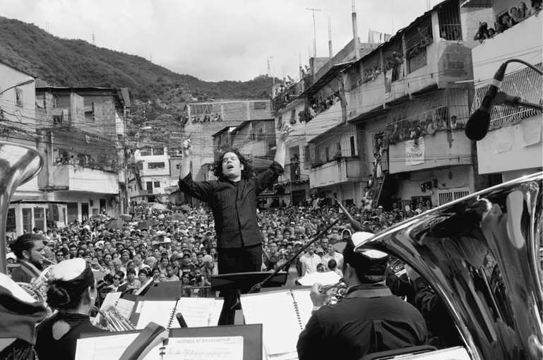 Dudamel conducting the Simn Bolvar Youth Orchestra in the Caracas barrio La - photo 14