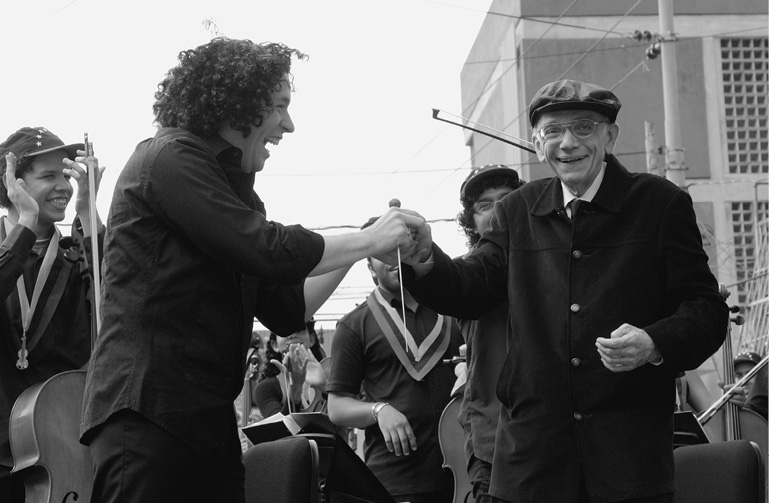 Maestro Abreu congratulating Dudamel at La Vega concert 2009 FESNOJIV - photo 15