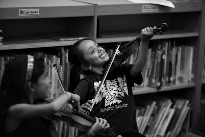 Childrens first moments with their violins at the ICAN Music Project in Santa - photo 26