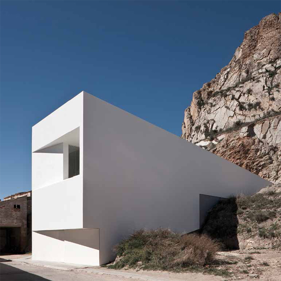 From outside the house looks like a wedge sunk into the rocky hillsi - photo 4