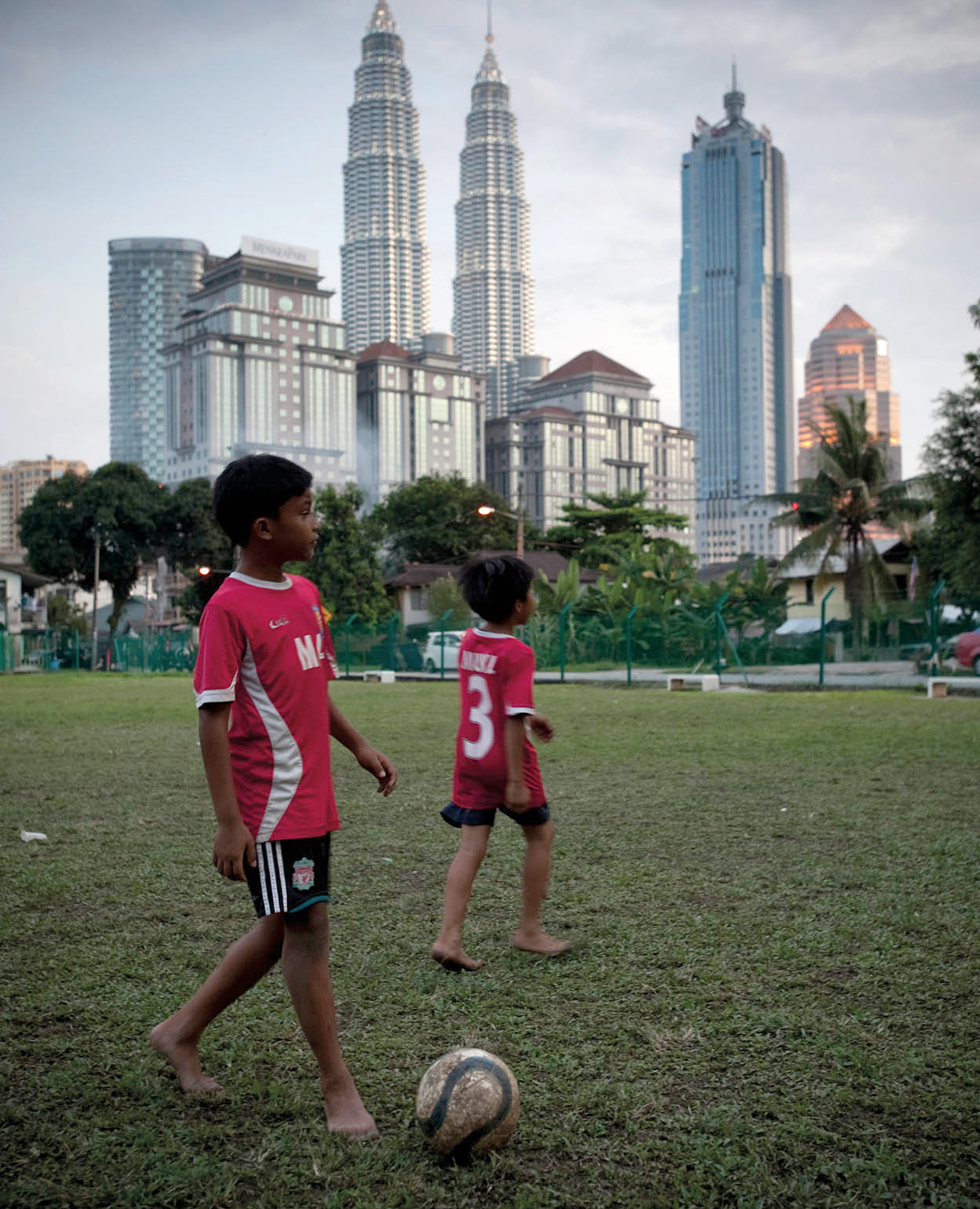 Boys playing in the shadow of the KLCC skyline James TyeApa Publications - photo 3