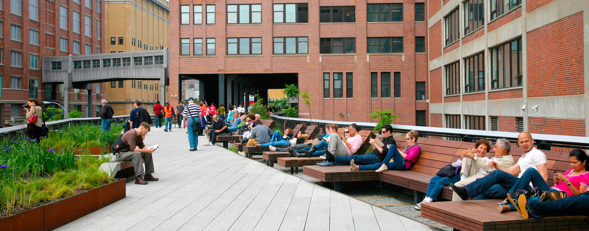 People relaxing along a section of the High Line an elevated public park - photo 9