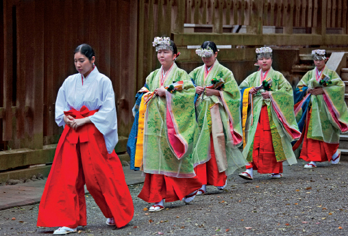 A procession of miko shrine maidens in ceremonial robes Buddhist Temples The - photo 14