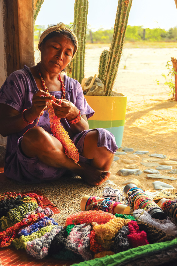 A woman knitting traditional handcrafts at Cabo de la Vela in La Guajira - photo 20