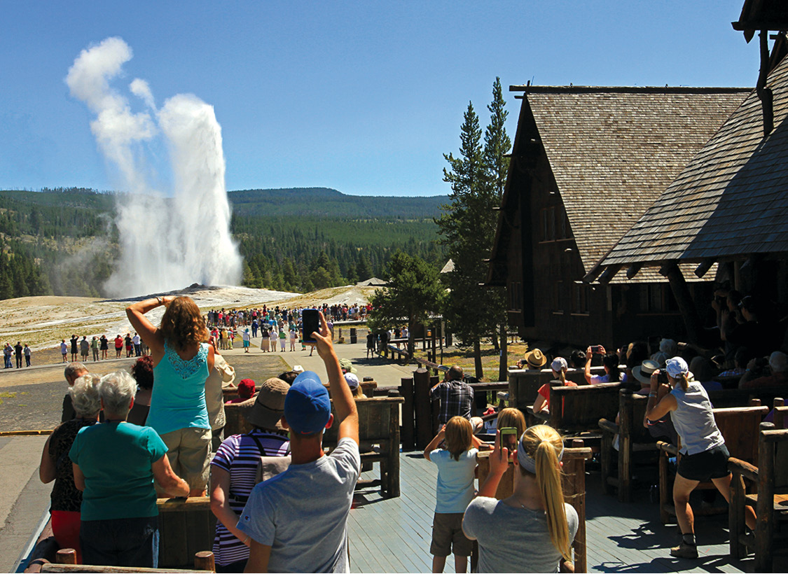 Visitors watch Old Faithful erupt from the porch of the Old Faithful Inn Built - photo 16