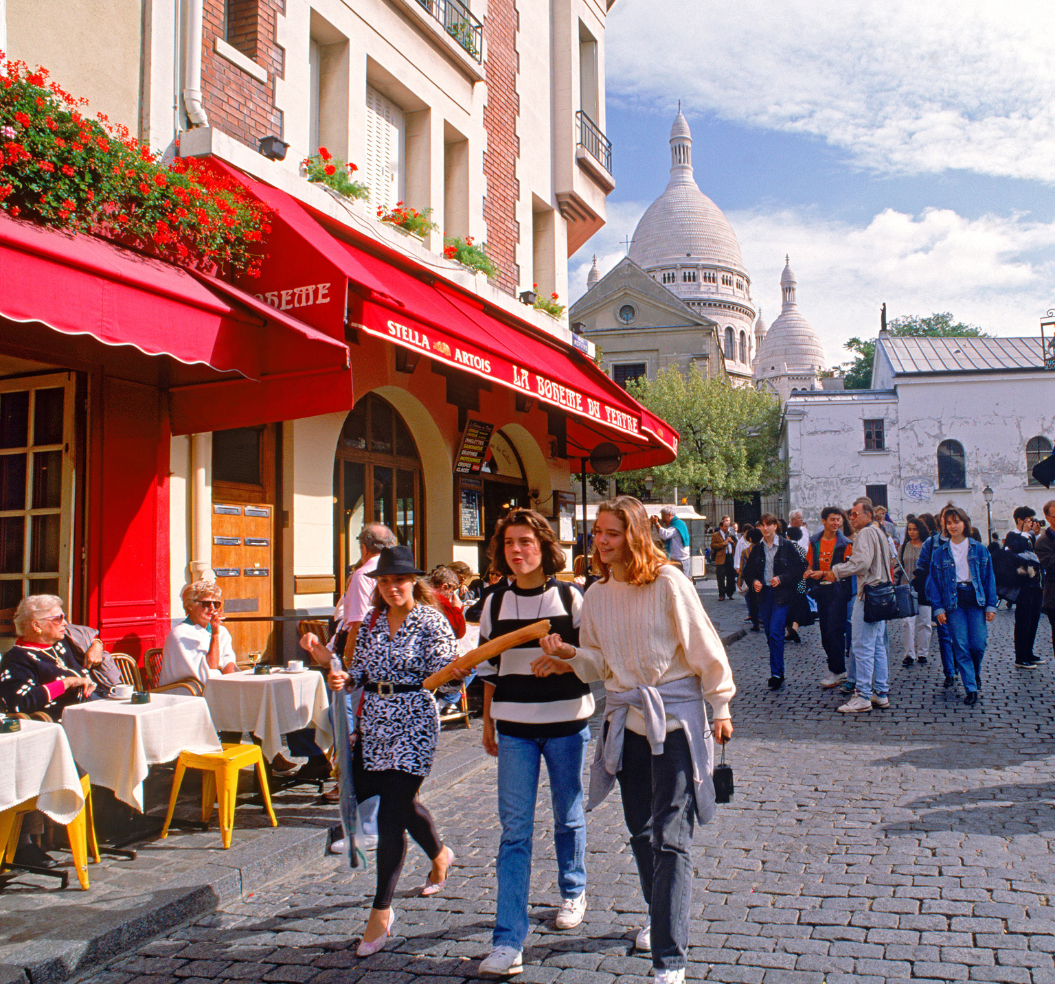 Strolling through the cobbled Place du Tertre with Sacr-Coeur in the - photo 6