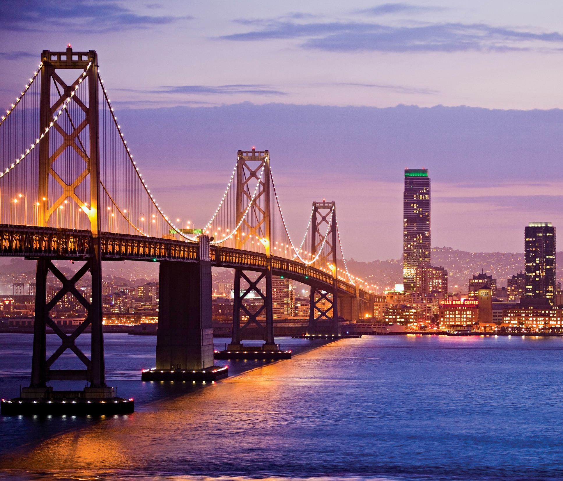 The lit-up Oakland Bay Bridge spans the San Francisco Bay - photo 6