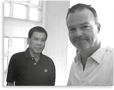 An author-selfie beside a cardboard cut-out of President Rodrigo Duterte in - photo 2