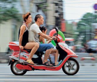 A couple and their child on a scooter Until recently urban couples could - photo 11