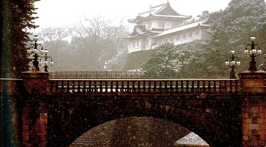 Snow falls on the Nijubashi bridge of the Imperial Palace in Tokyo I f - photo 3