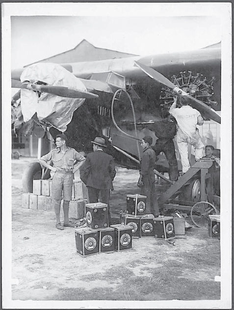 Charles Ulm overseeing the refuelling and mechanical checks of the Southern - photo 2