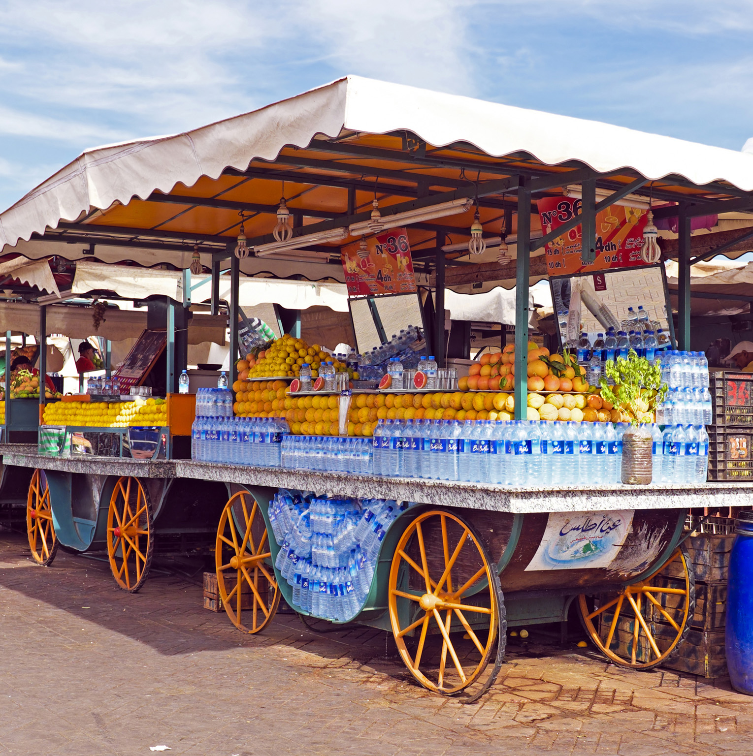 Brightly painted juice stalls Porters With cars banned from crossing Jemaa - photo 14