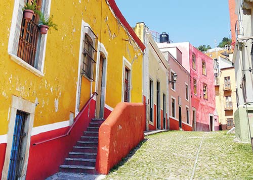 colorful pedestrian alley in Guanajuato artisan embroidering in - photo 12