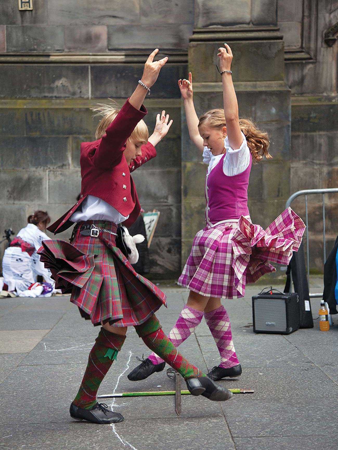 Highland dancers stepping over crossed swords practice the Sword Dance THE - photo 12