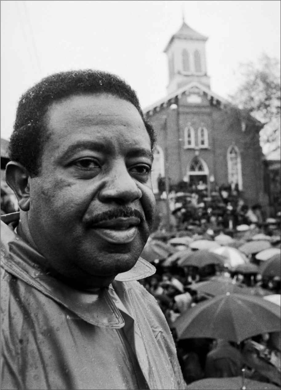 Civil rights activist Ralph Abernathy pictured here at a rally in the rain at - photo 16