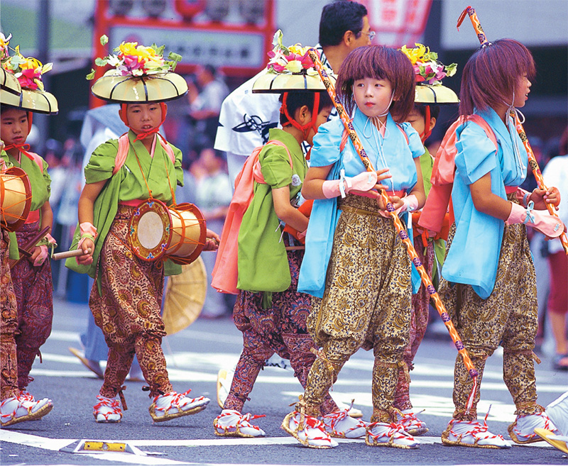 A Gion Festival parade on Shijo-dori Boys in festival attire ride atop a - photo 14