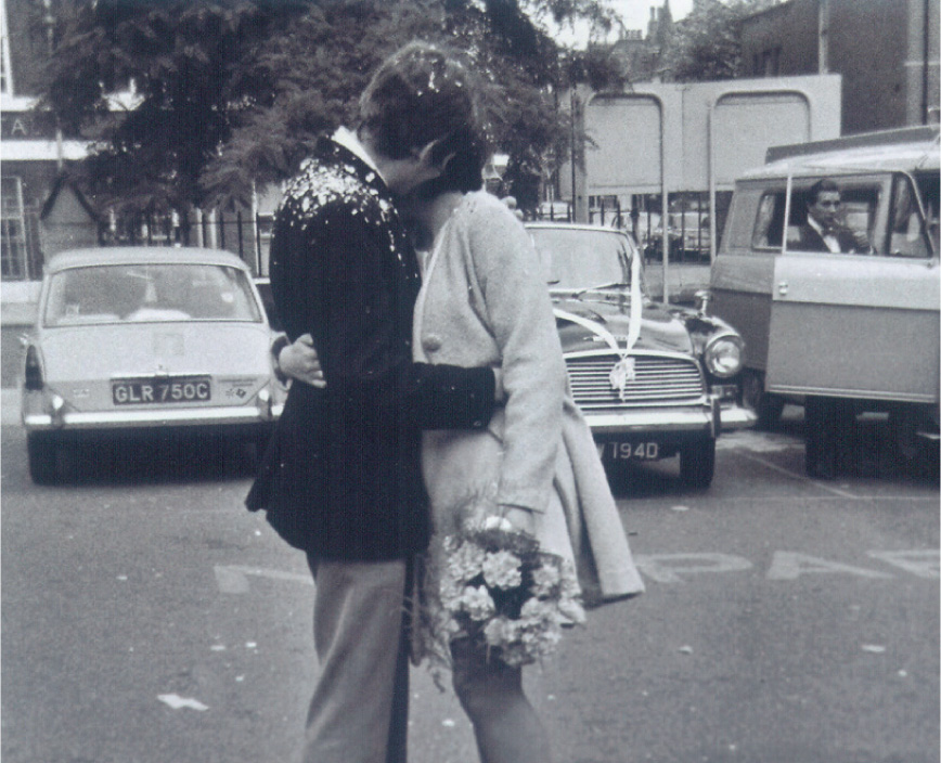 Judy and me on our wedding day posing in front of somebody elses beribboned - photo 15