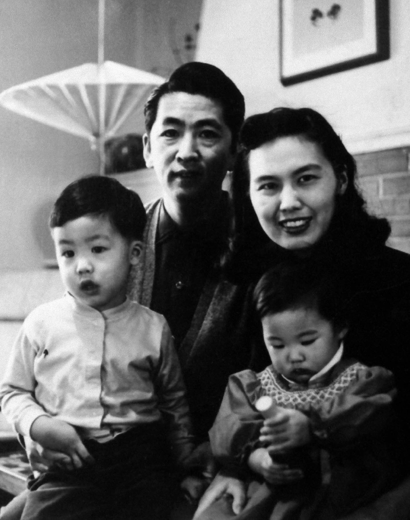 Maya around age one with her brother Tan and their parents in their home in - photo 5