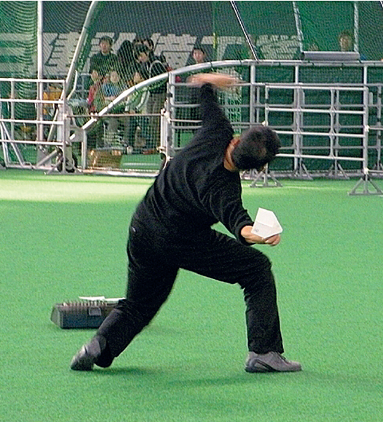 Takuo Toda winding up to launch a paper airpline for a longest flight duration - photo 2