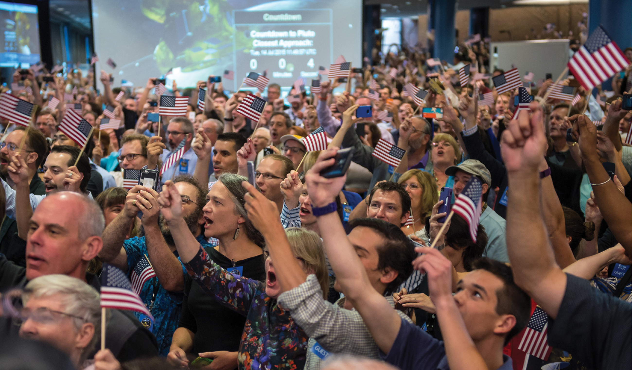 THE CROWD GOES WILD AS NEW HORIZONS FLIES THROUGH THE PLUTO SYSTEM The large - photo 2