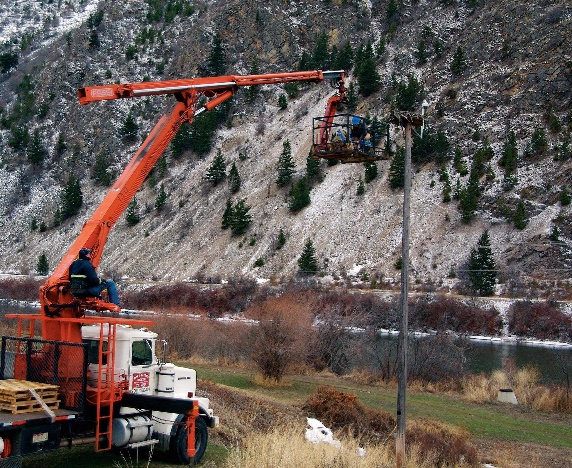 The roofing truck lifts Erick Greene and Heiko Langner up to check on and clean - photo 2