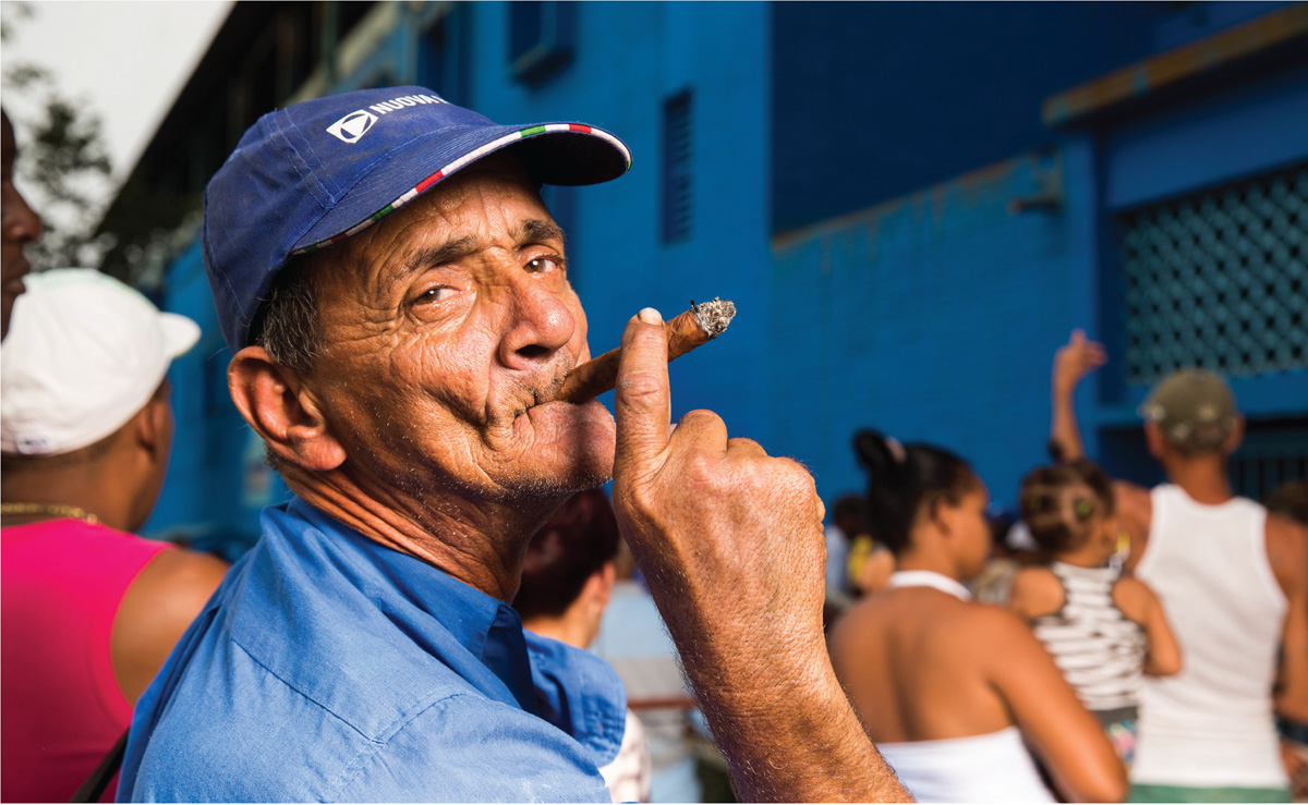 Cigar-smoking fan entering Estadio Latinoamericano Havana Fans Estadio - photo 5