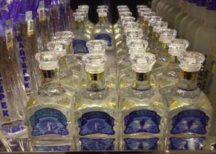 Locally made vodka bottles displayed in a glass case at an airport in - photo 6