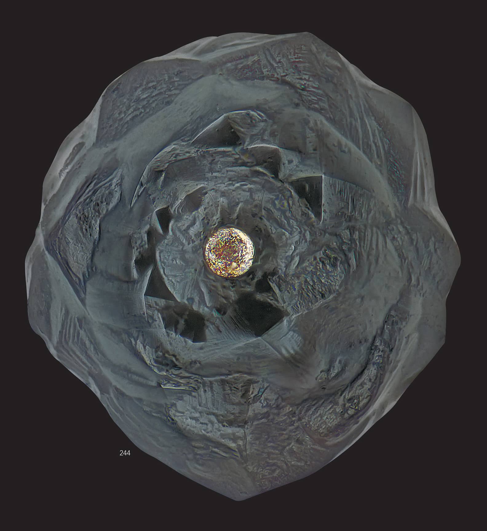 A fine-grained turtleback micrometeorite with a nickeliron core in the front - photo 4