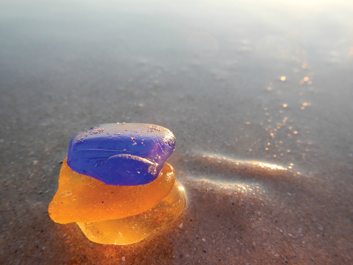 Icy-looking sea glass on a warm beach - photo 25