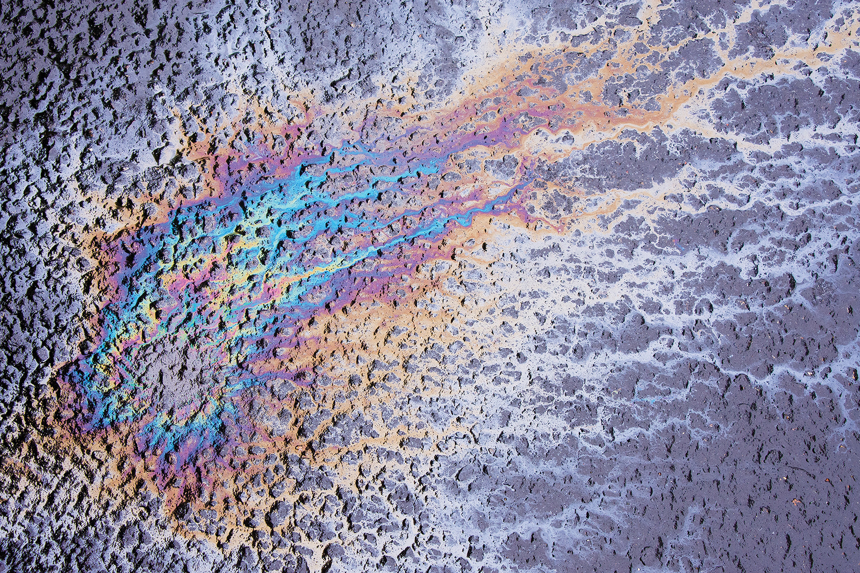 Motor oil stains in a wet parking lot offer a kaleidoscope of color No doubt - photo 7