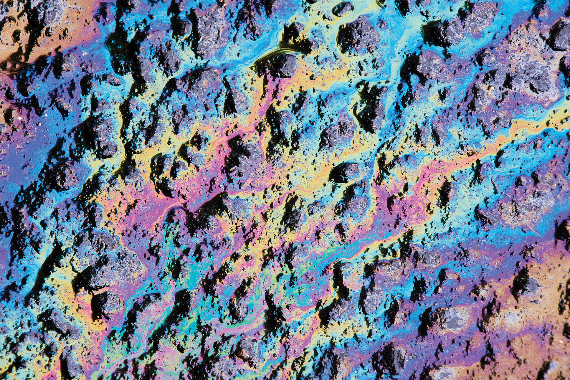 Motor oil stains in a wet parking lot offer a kaleidoscope of color No doubt - photo 8