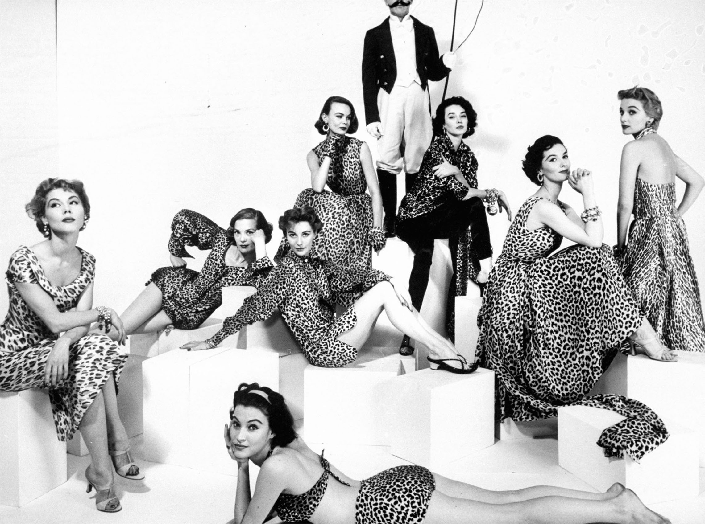 A group of models poses luxuriously in leopard print 1953 The faceless man in - photo 2