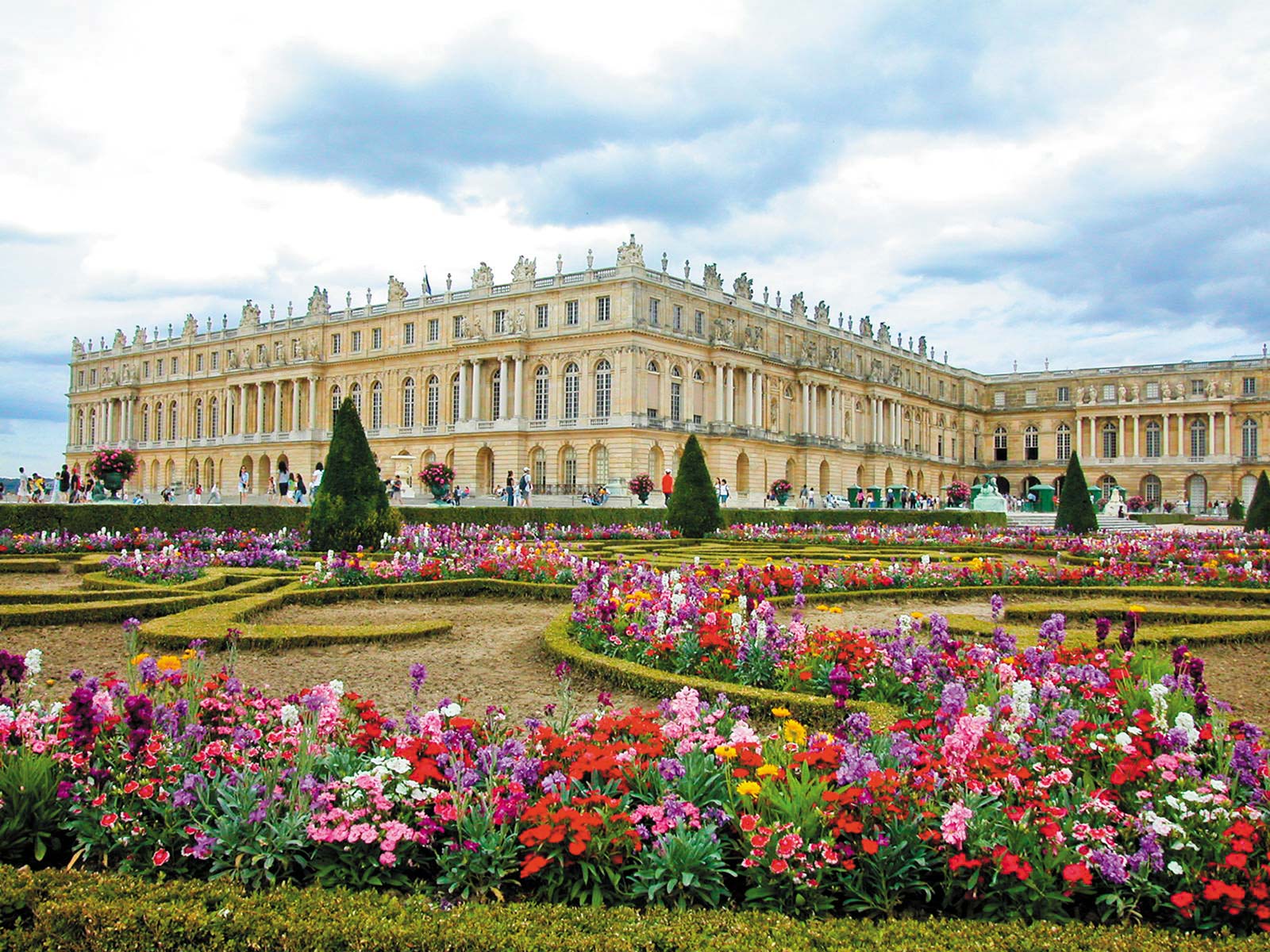 Versailles colorful gardens lead into a vast park with ponds fountains and a - photo 11