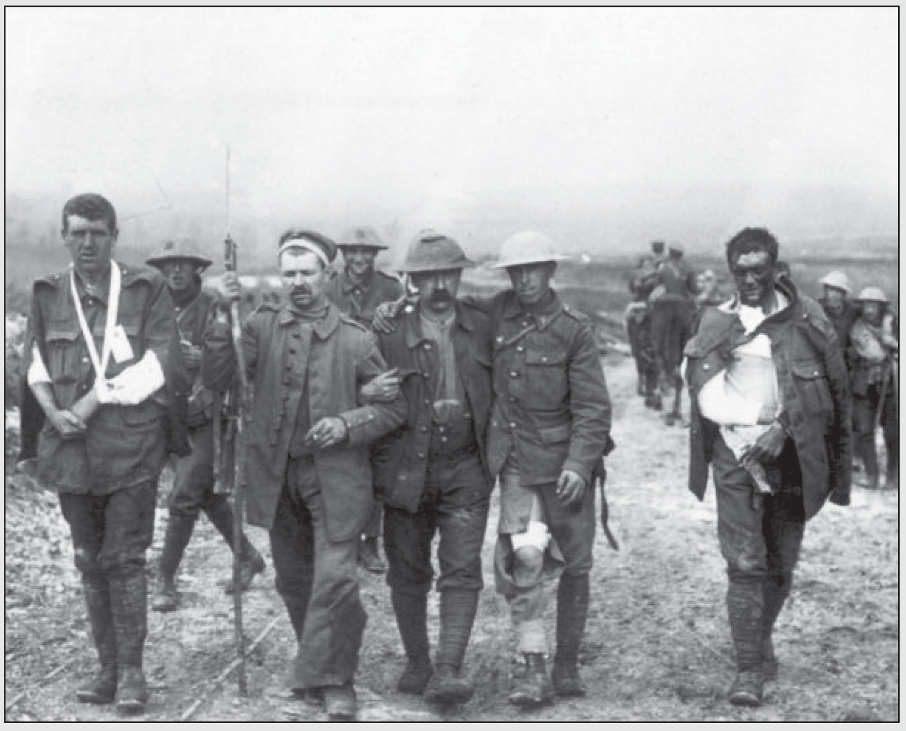 A German soldier helps British wounded make their way to a first-aid station - photo 1