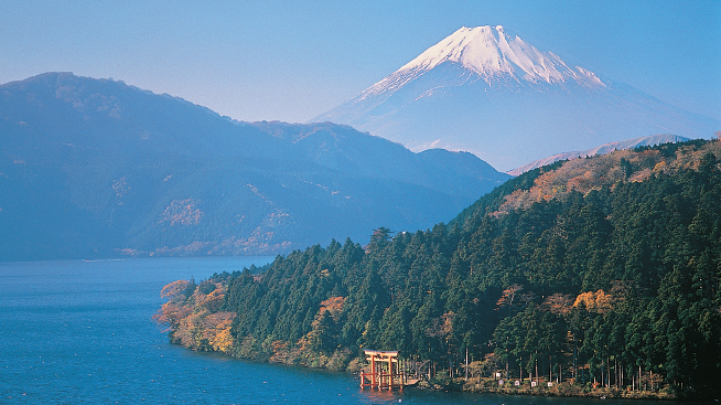 Rounded mountains lushly forested rise up out of a lake forming a contrast - photo 7