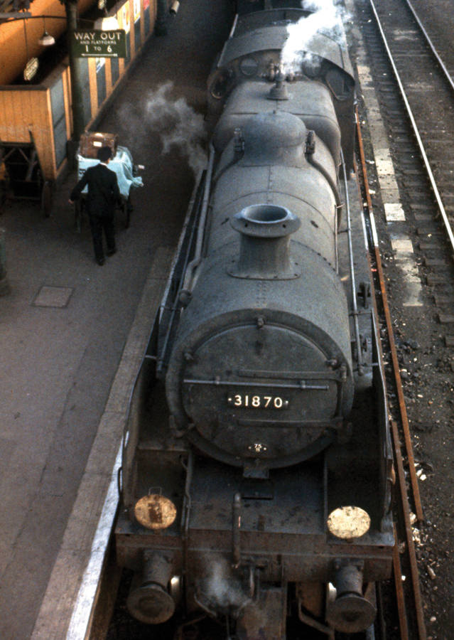 At Guildford in 1963 ex-Southern N class no 31870 waits while a porter takes - photo 4