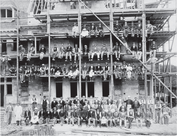 A large team of builders from the early twentieth century wearing flat caps - photo 6