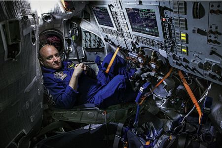 Before his launch astronaut Scott Kelly sits inside a Soyuz simulator at the - photo 6