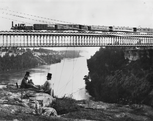 A steam train crosses the Railway Suspension Bridge over the Niagara River New - photo 10