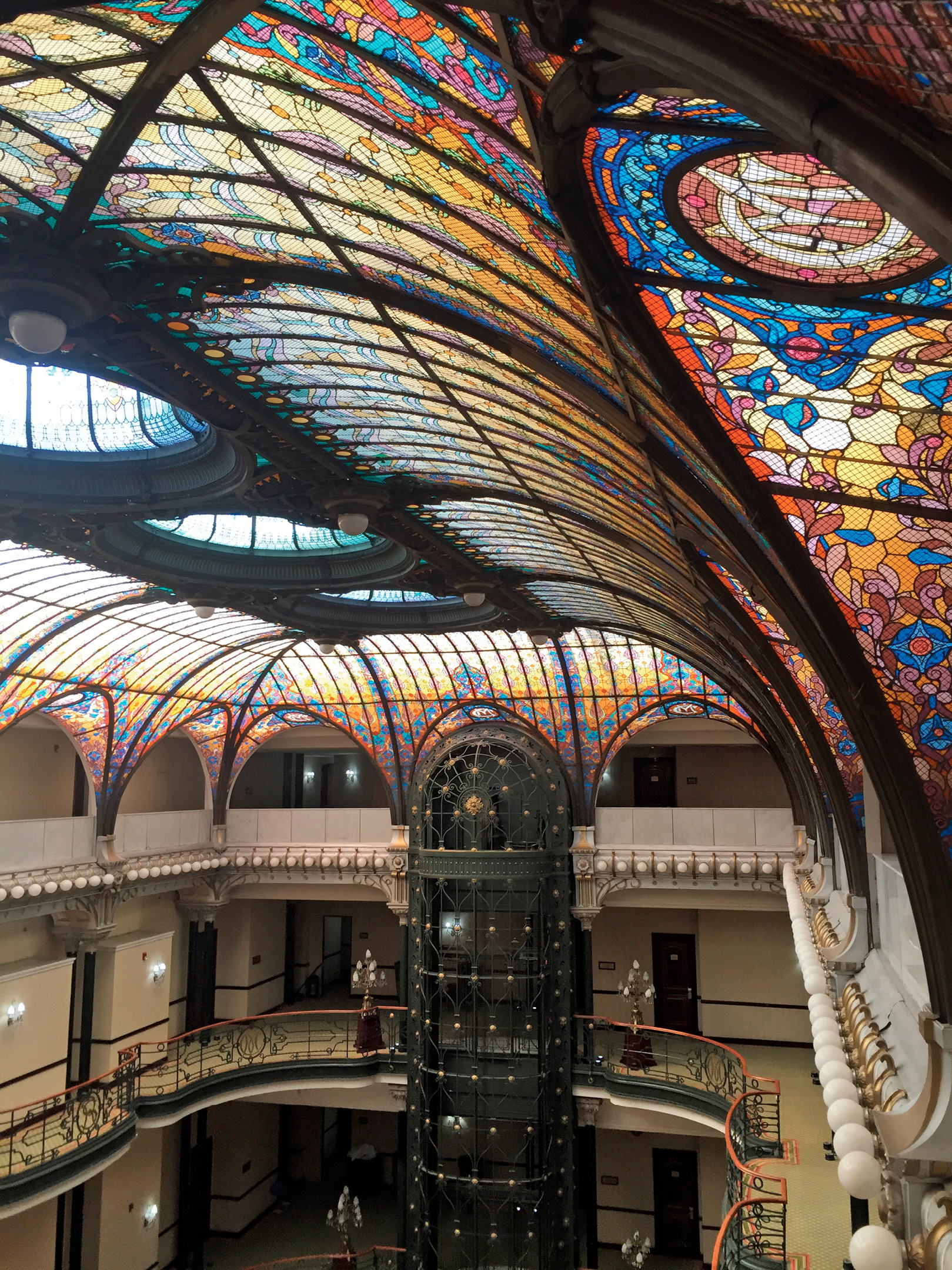 Step inside this historic hotel and look up at the massive stained-glass - photo 3