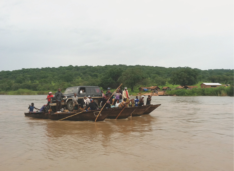 Crossing the river in the Congo on the so called ferry made up of canoes - photo 11