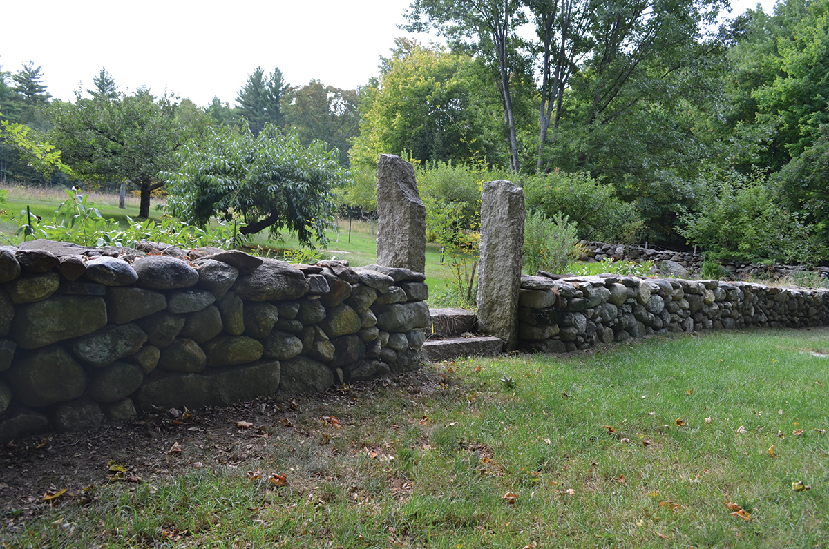 Antique fence posts and a stepped opening break this double-faced wall to give - photo 3