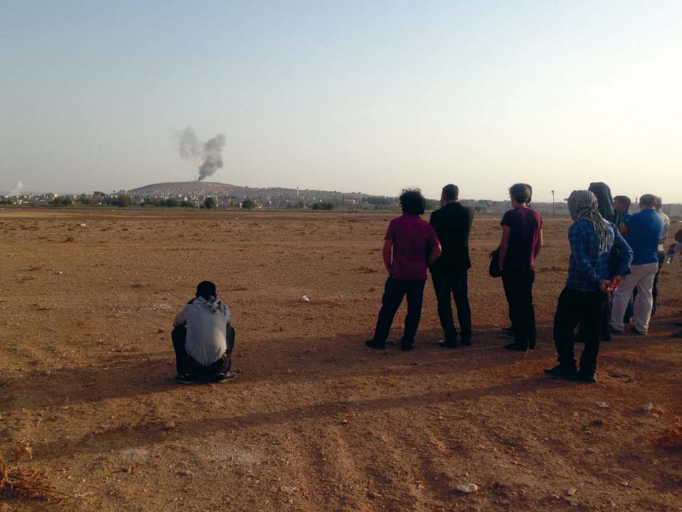 Kurds watch Koban burn across the TurkeySyria border September 2014 An - photo 13