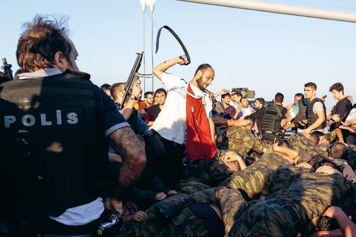 Erdoan supporters flock onto Istanbuls Bosphorus Bridge and attack surrendering - photo 23