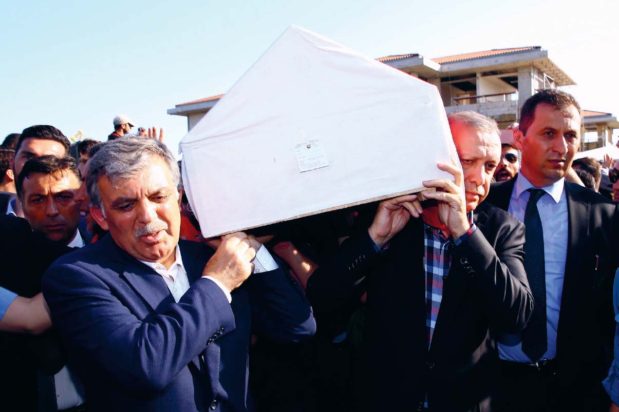 Erdoan and former president Abdullah Gl carry Erol Oloks coffin at his funeral - photo 26