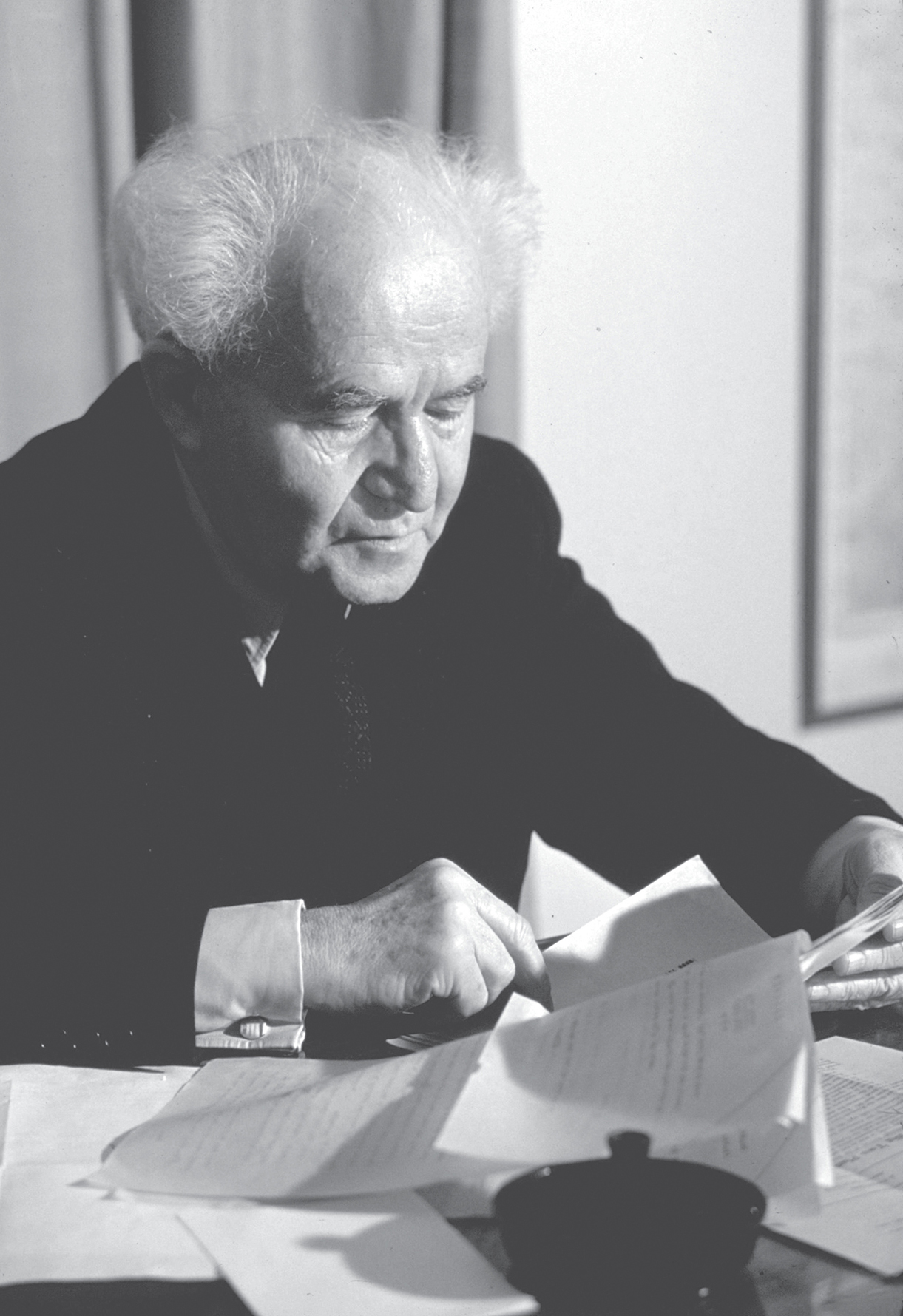 Prime Minister David Ben-Gurion looking through documents at his Tel Aviv - photo 2