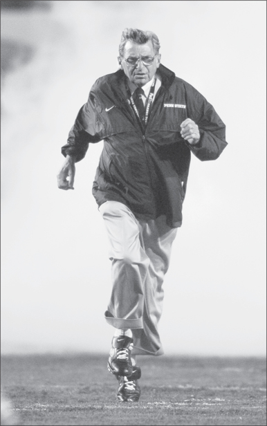 Joe Paterno runs through the smoke and onto the field before the 2006 Orange - photo 2