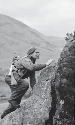 A soldier from No 1 Commando armed with a Model 1928A1 Thompson climbs up a - photo 6