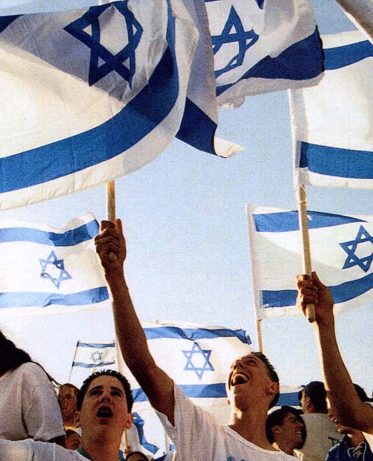 Young people supporting Ehud Baraks One Israel party wave flags at a rally - photo 3